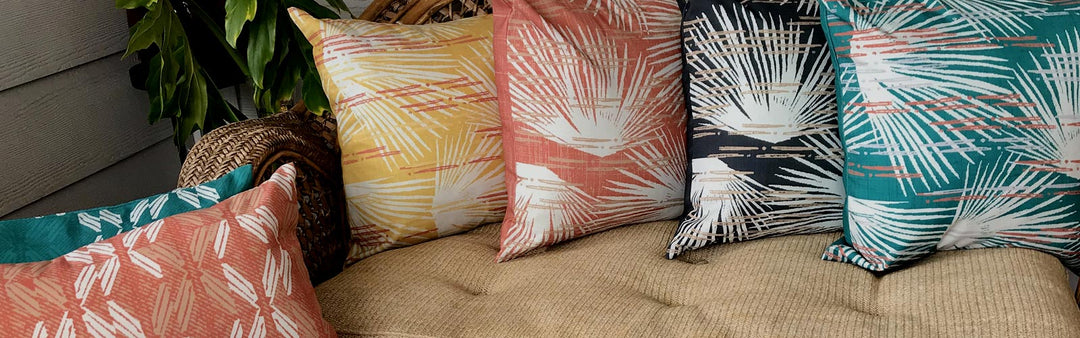 Coastal Decor Pillows Shown on a Couch with Various Hawaiian Print Designs