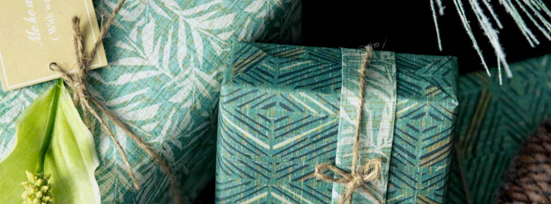 Coastal Christmas Decor Hawaiian Style Showing Boxes Wrapped in Paper and a X-Mas Tag on One