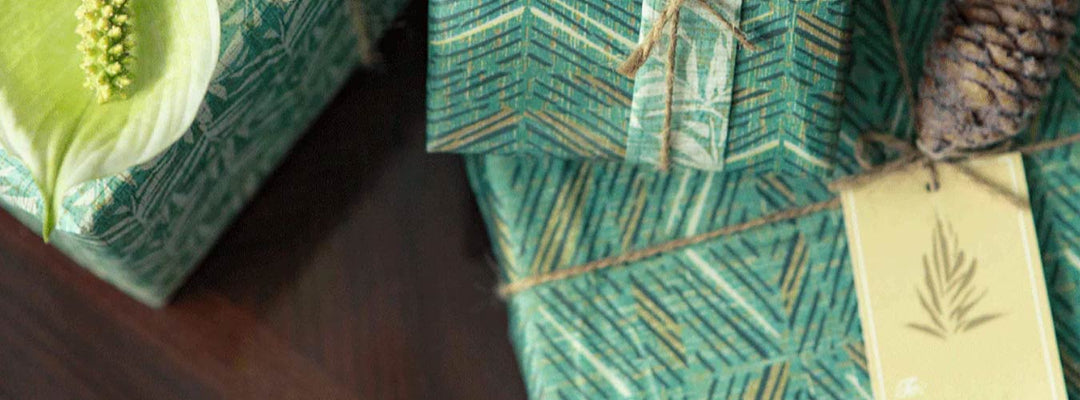 Hawaiian Wrapping Paper Shown In Green Print Wrapped With Twine Around Small Boxes