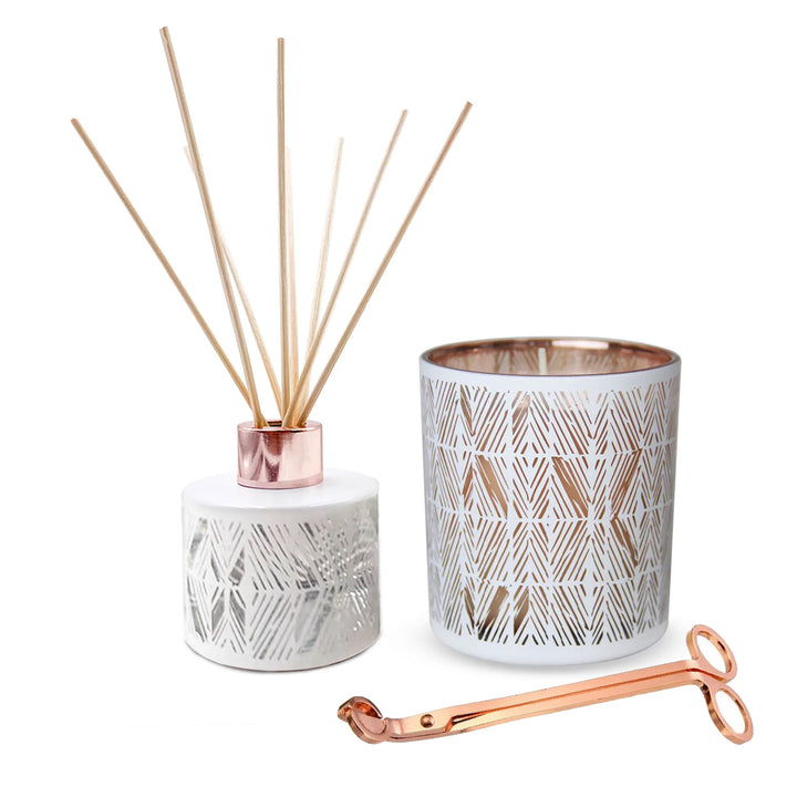 gardenia scented diffuser and candle plus rose gold wick trimmer on white background