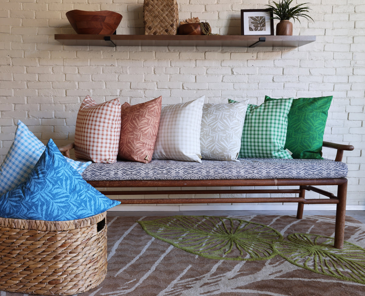 Sofa with patterned cushions and a woven basket in a living room setting.