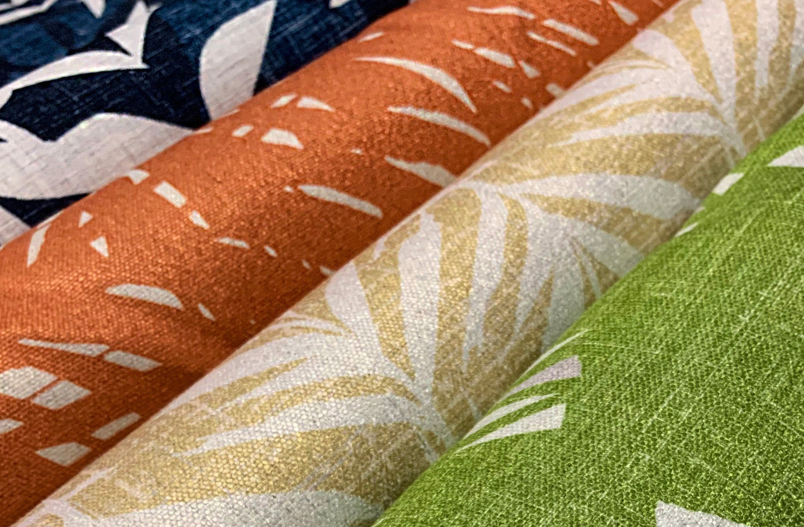 Wholesale and Trade Resources for Authentic Hawaiian Design Services Showcasing Hawaiian Print Fabrics in Orange, Tan and Green