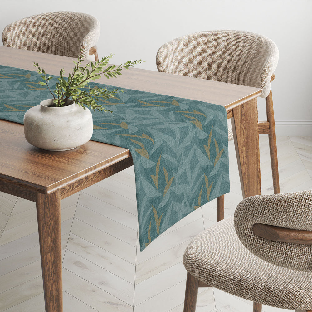 Teal Lele Table Runner draped over table, with potted plant and surround by mid-century modern chairs.