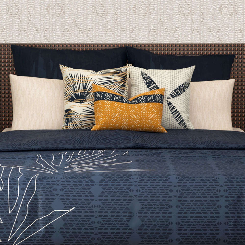 Close-up of Hōʻolu Hiamoe Comforter In Dark Blue On a Large Bed With Orange and Hawaiian Print Decor Pillows