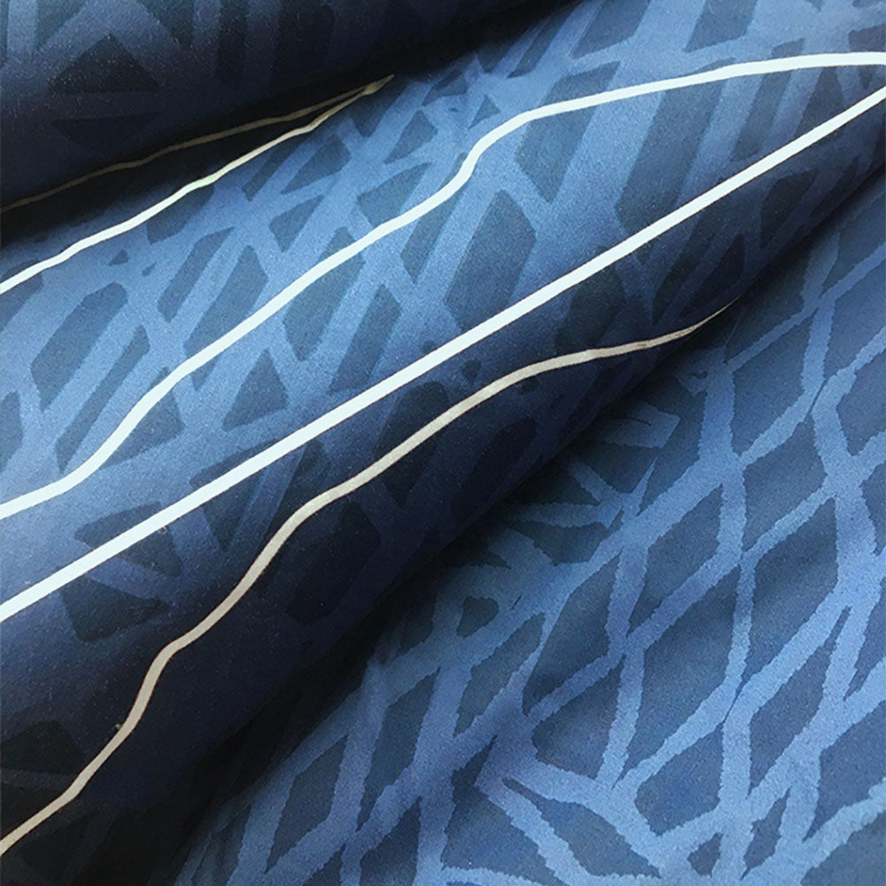 Closeup to show pattern of Hōʻolu Hiamoe Coastal Comforter In Dark Blue