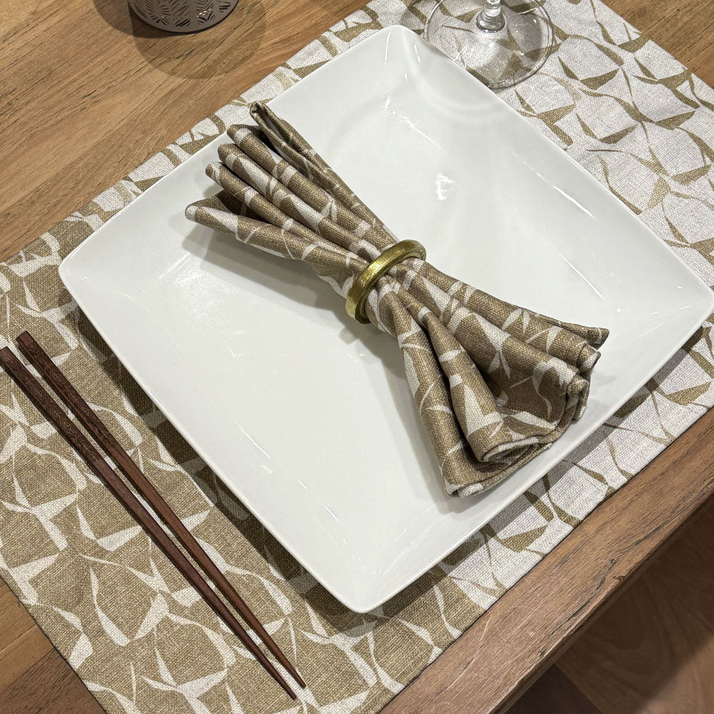 One Premium ʻEke Dining Napkin In a Gold Napkin Holder On a Platter