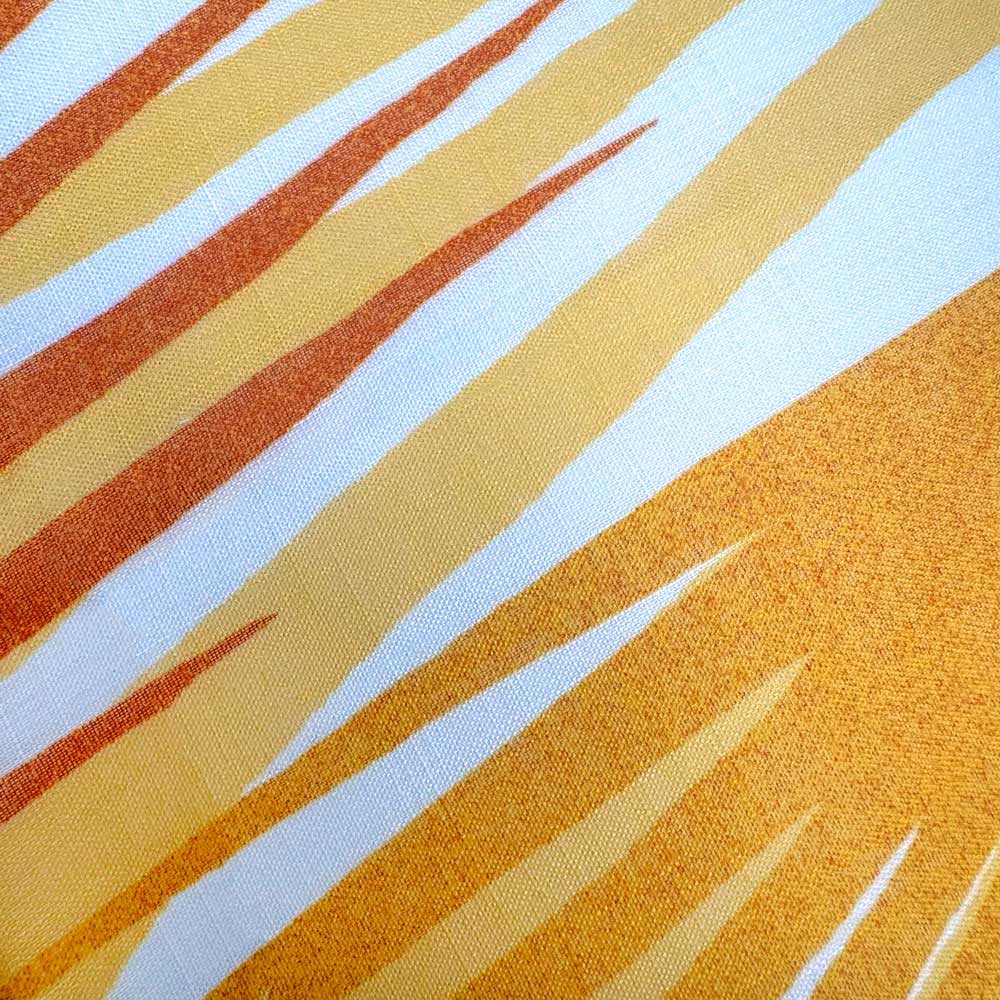 Closeup of the Lilikoʻi Orange and Gold Pattern of the Loulu Travel Wrap