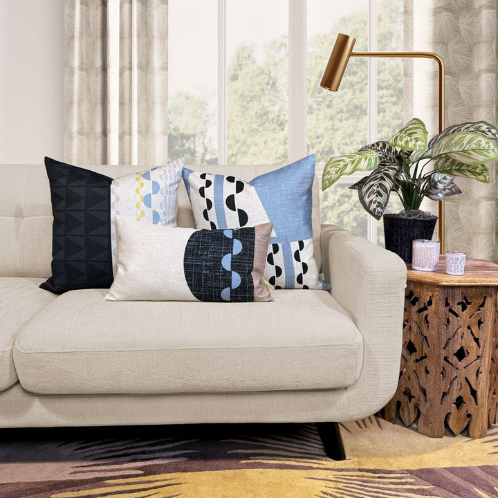 Black and Beige Tatau Kau Lumbar Pillow Set with the Tatau Pillow Capsule On a Beige Couch