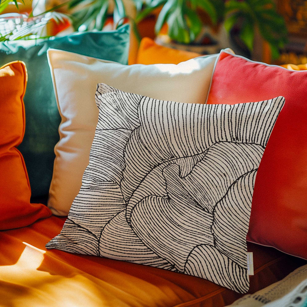 Gardenia Petals Square Pillowcase Set On an Orange Cushion With Décor Pillows Behind It