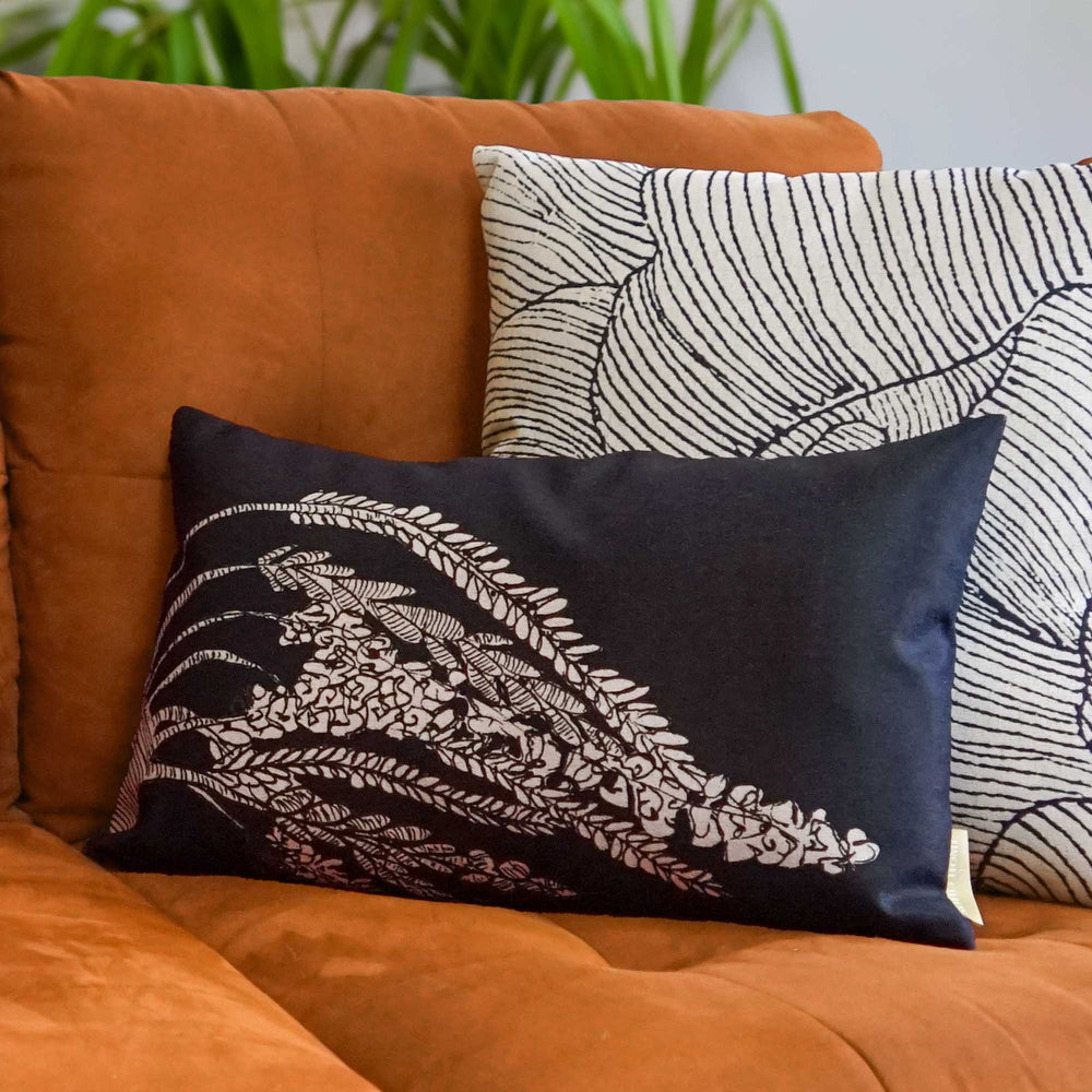 Ryokō-sha Lumbar Pillow Set On an Orange Couch With a Coastal Décor Pillow Behind It