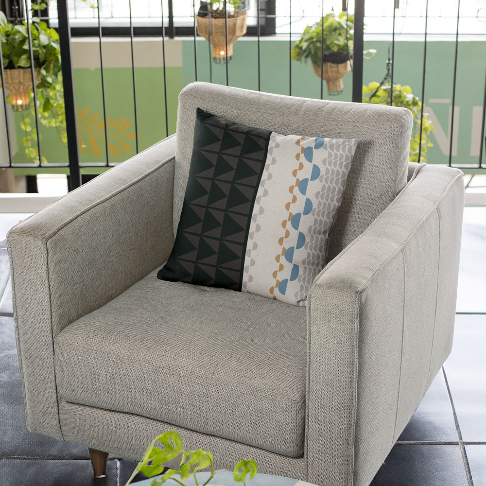 Black and Beige Tatau Pō Square Pillow Set On a Beige Lounge Chair