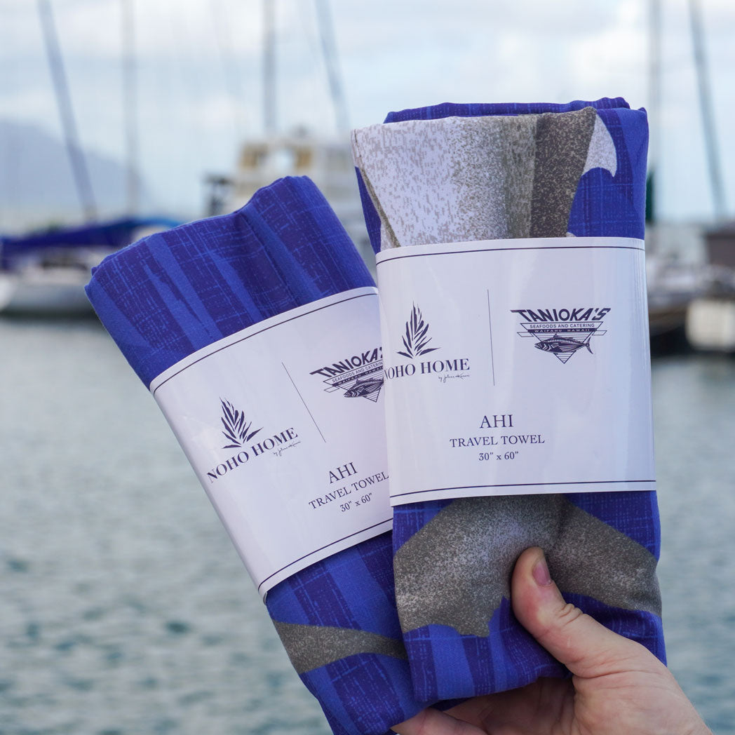 two wrapped blue microfiber travel towel with ahi fish print