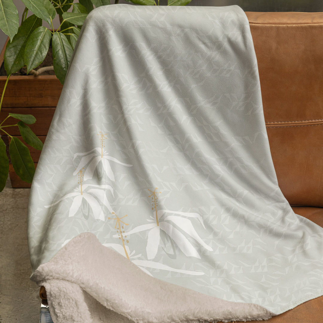 Kokiʻo Keʻokeʻo cozy throw on chair 