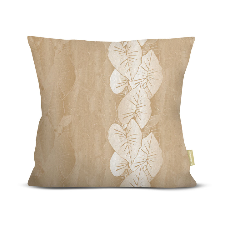 Beige pillow with white kalo leaf pattern on a white background.
