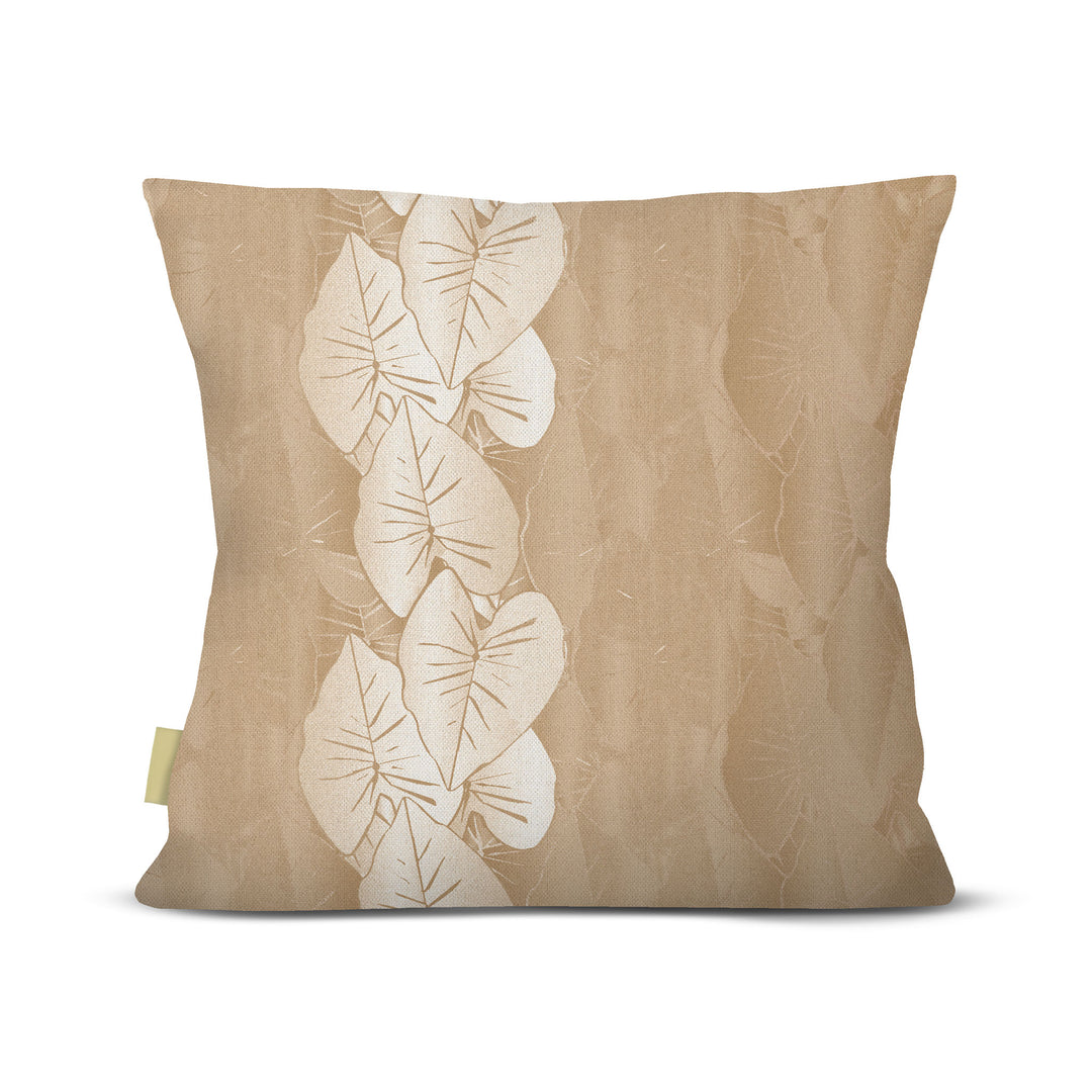 Beige pillow with white kalo leaf pattern on a beige background
