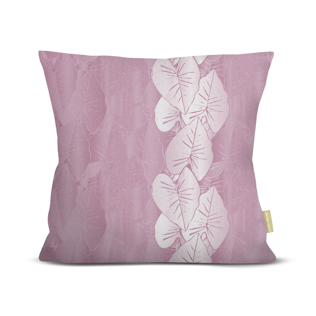 Lavender pillow with white kalo leaf design on a white background.