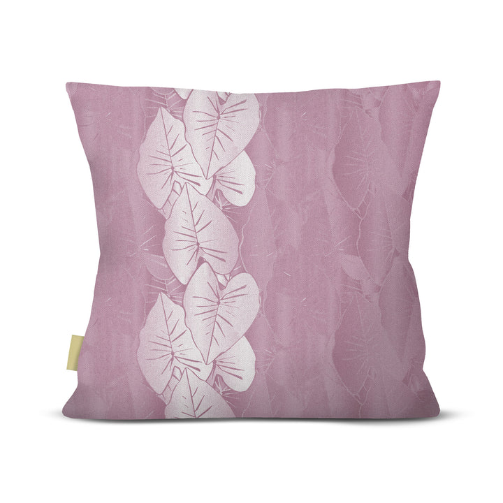 Decorative pillow with white kalo leaf pattern on a pink background