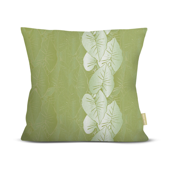 Green pillow with white kalo leaf pattern on a white background