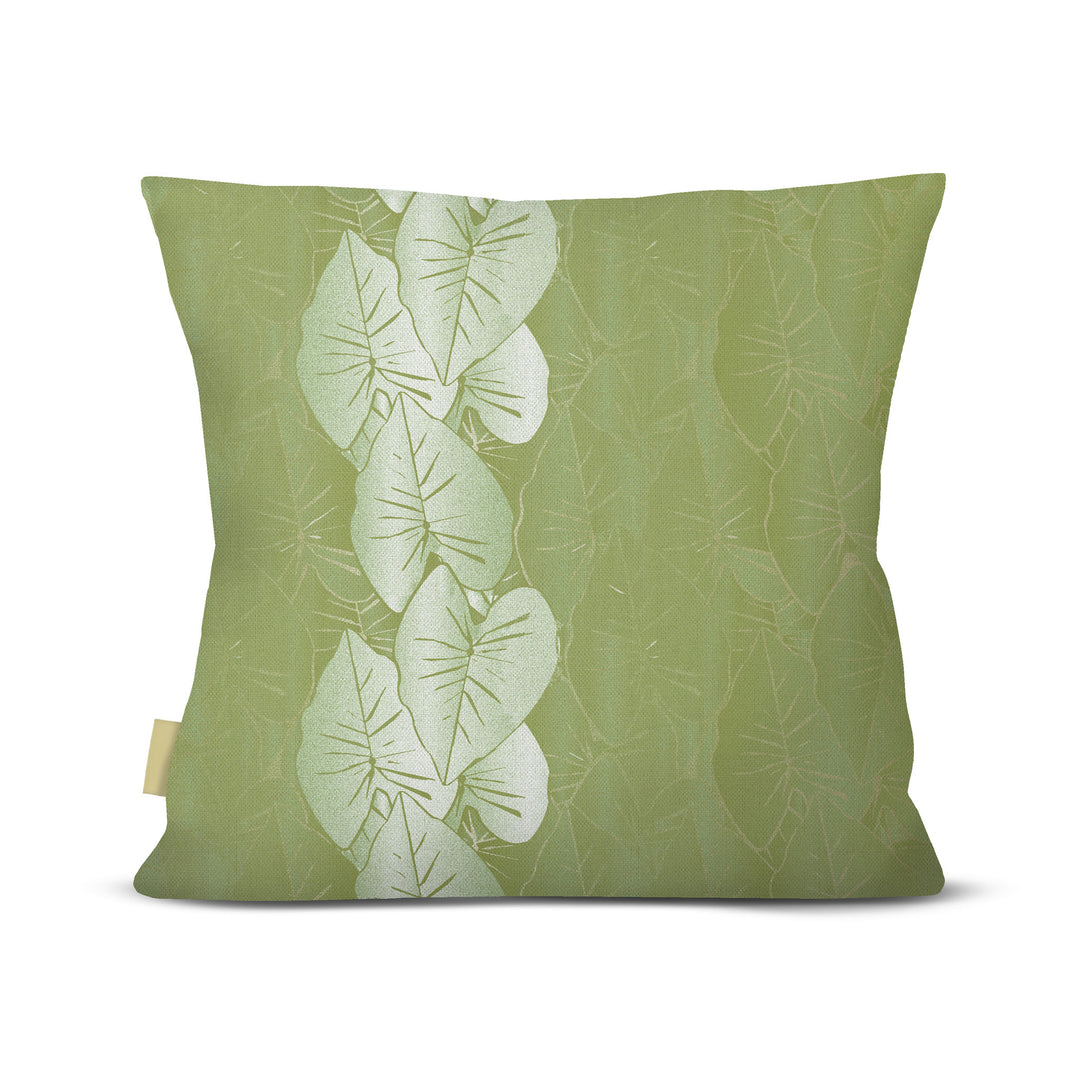 Green pillow with leaf pattern on a white background