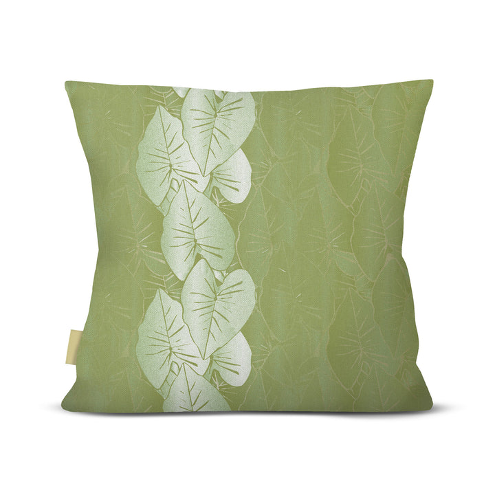 Green pillow with leaf pattern on a white background
