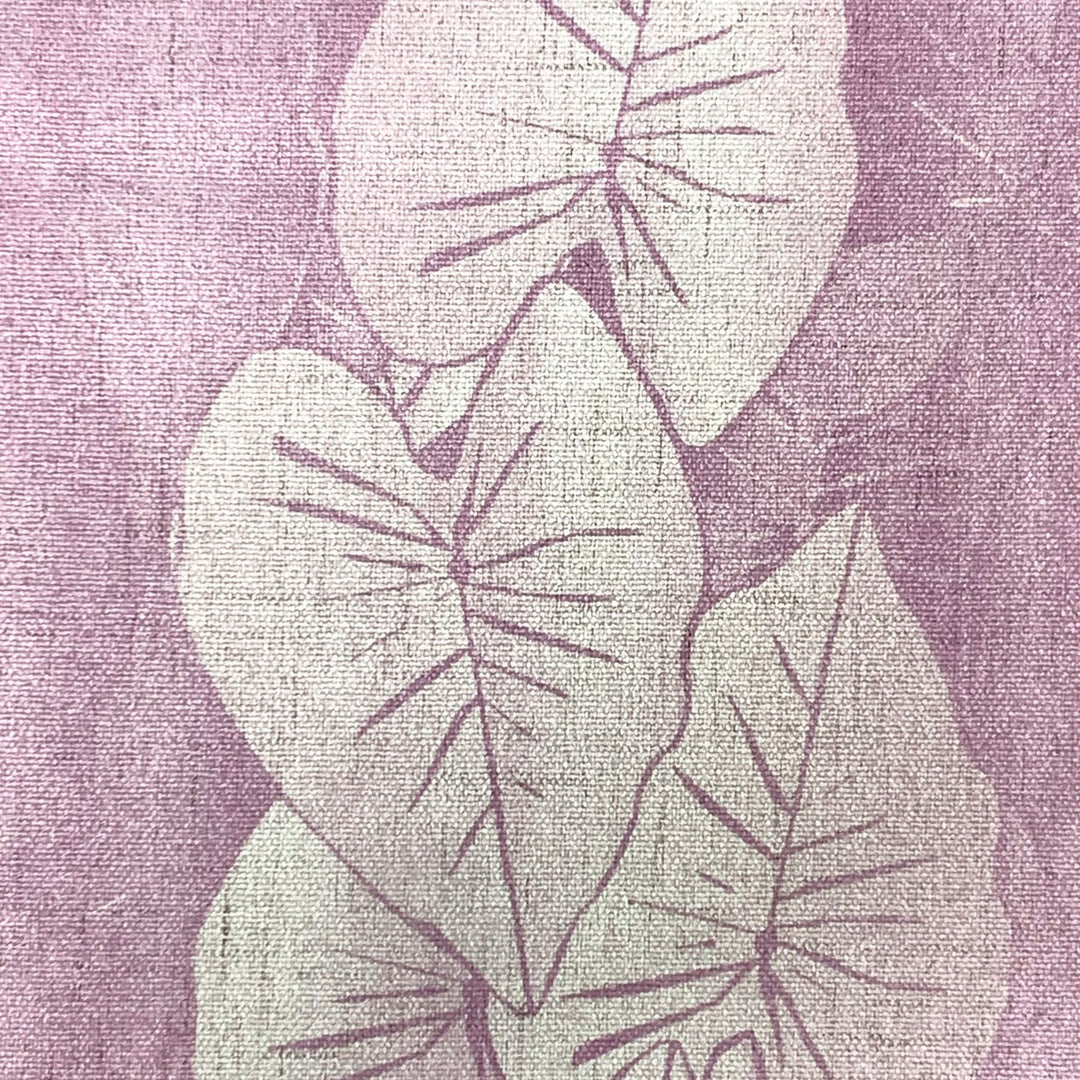 Decorative fabric with kalo leaf pattern on a textured purple background