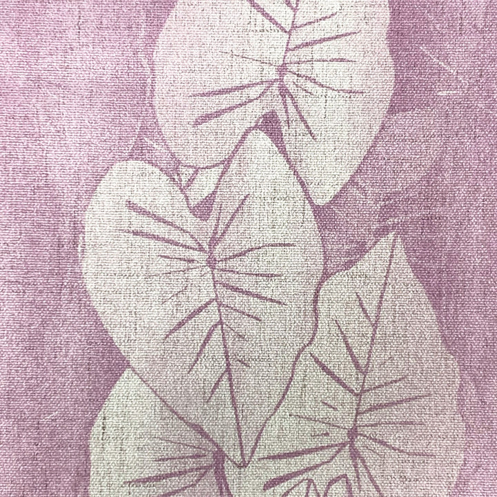 Decorative fabric with kalo leaf pattern on a textured purple background