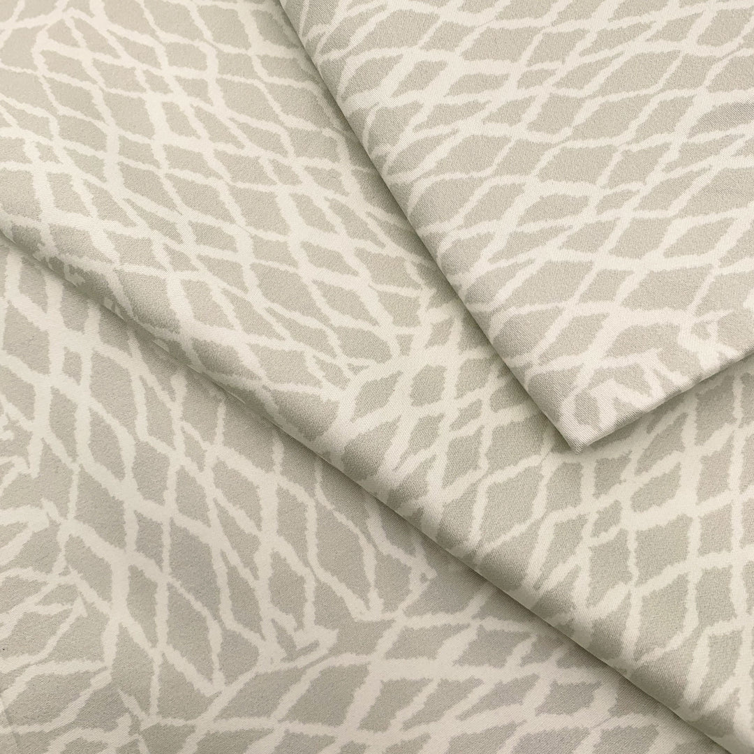 Close view of the white ʻUpena fishnet print on a NOHO HOME bed pillowcase