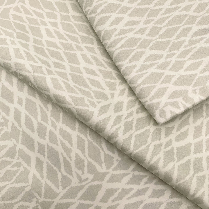 Close view of the white ʻUpena fishnet print on a NOHO HOME bed pillowcase