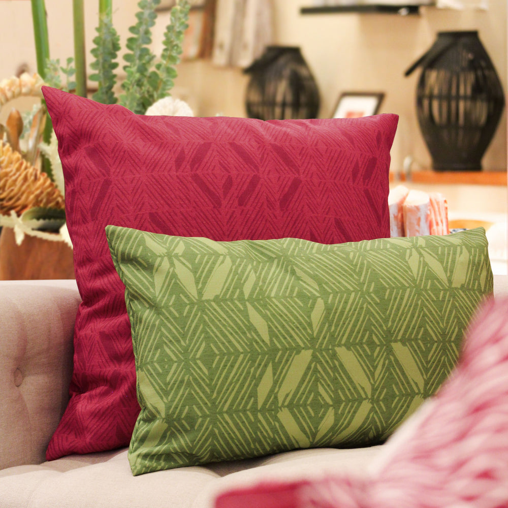 Red ʻAkahi Square Pillowcase With a Lumbar Pillow in Front of It