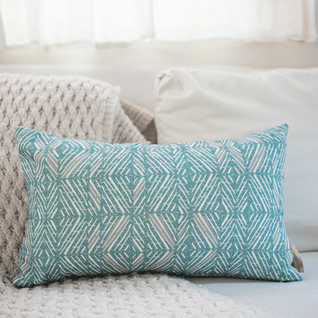 Snow & Frost 'Akahi Lumbar Pillowcase against an ivory sofa and ivory pillows