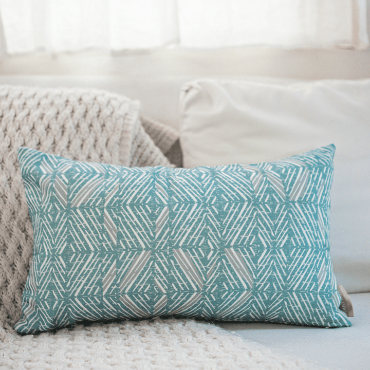 Snow & Frost 'Akahi Lumbar Pillowcase against an ivory sofa and ivory pillows