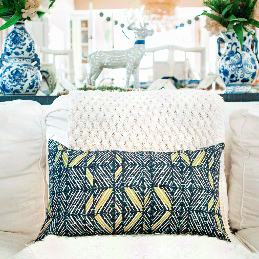 Moss & Navy 'Akahi Lumber Pillowcase on an ivory sofa with China Blue pottery and ivory dining set in the background
