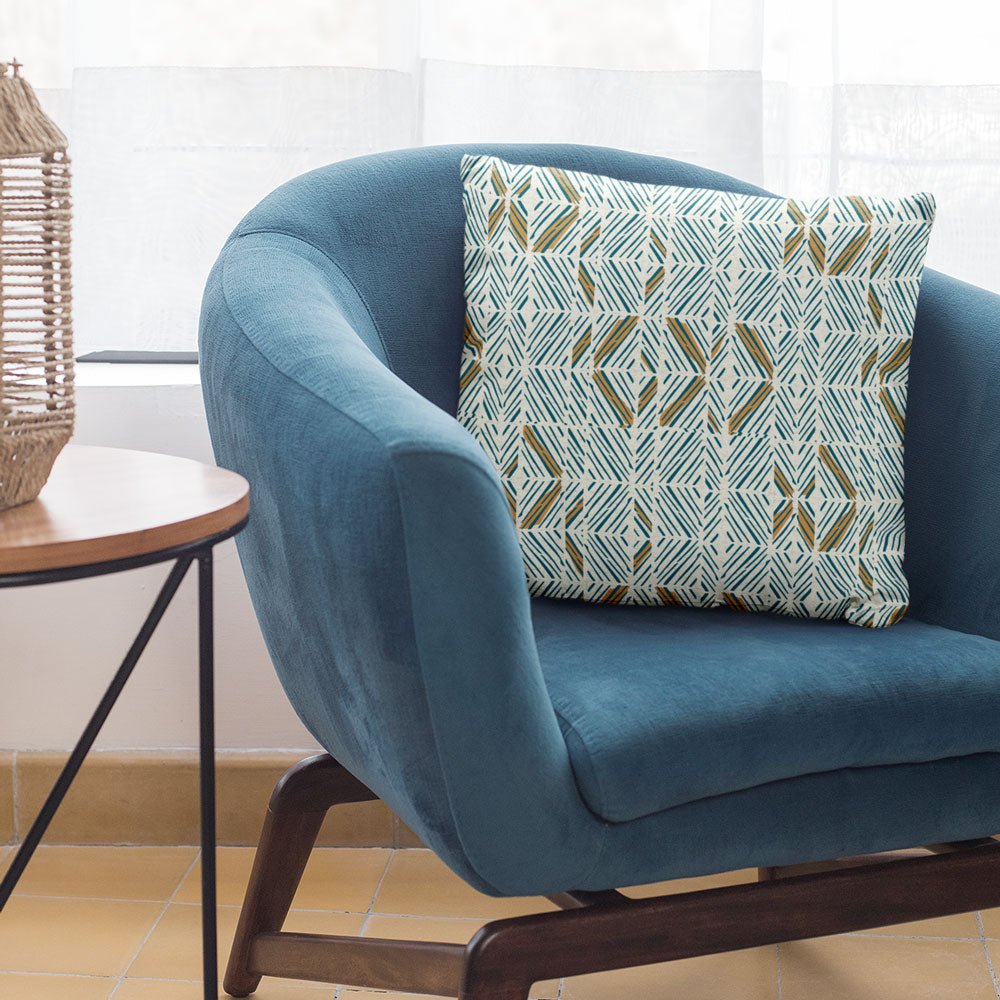 Ocean Color ʻAkahi Square Pillow Set On a Blue Chair