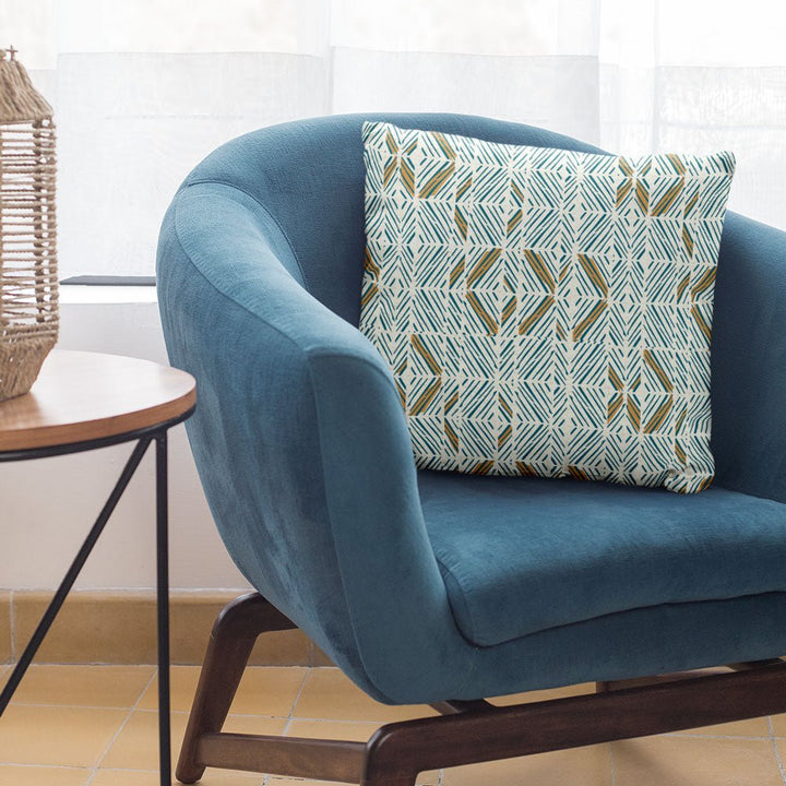 Ocean Color ʻAkahi Square Pillow Set On a Blue Chair