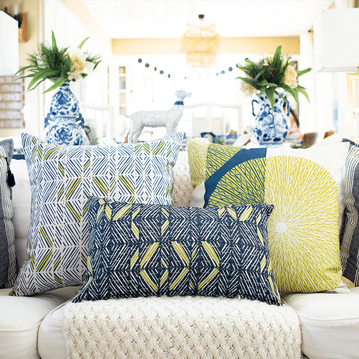Moss & Navy & Ivory ʻAkahi Square Pillow Set on a White Fabric Couch With a Lumbar and Other Square Pillow Next to It