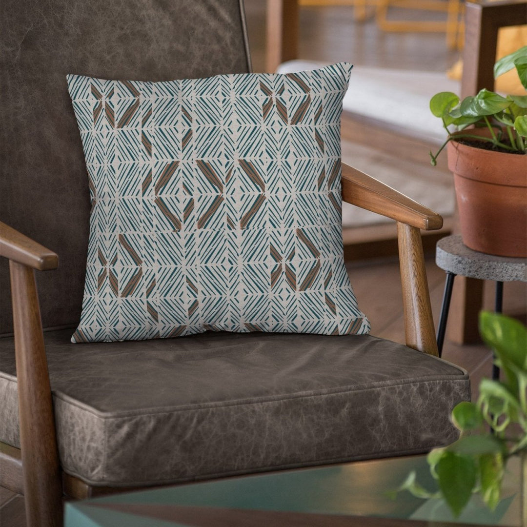 Aqua & Cocoa & Ivory ʻAkahi Square Pillow Set On a Leather Chair