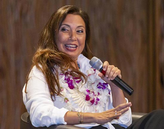 Jalene Kanani Smiling and Speaking Holding a Microphone During a Speaking Panel