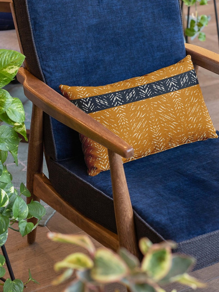 Rust & Navy Batik Lumbar Pillow ON a Blue Velvet Chari