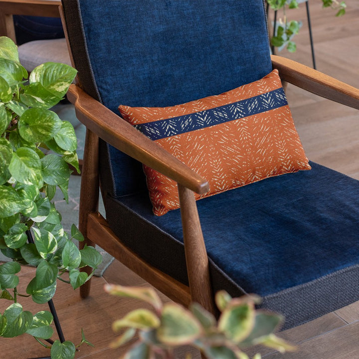 Rust & Navy Batik Lumbar Pillow Set On a Blue Velvet Chair