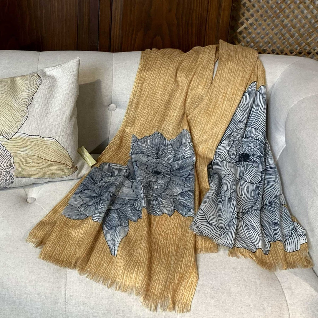 Gardenia Travel Wrap Laying On a White Couch