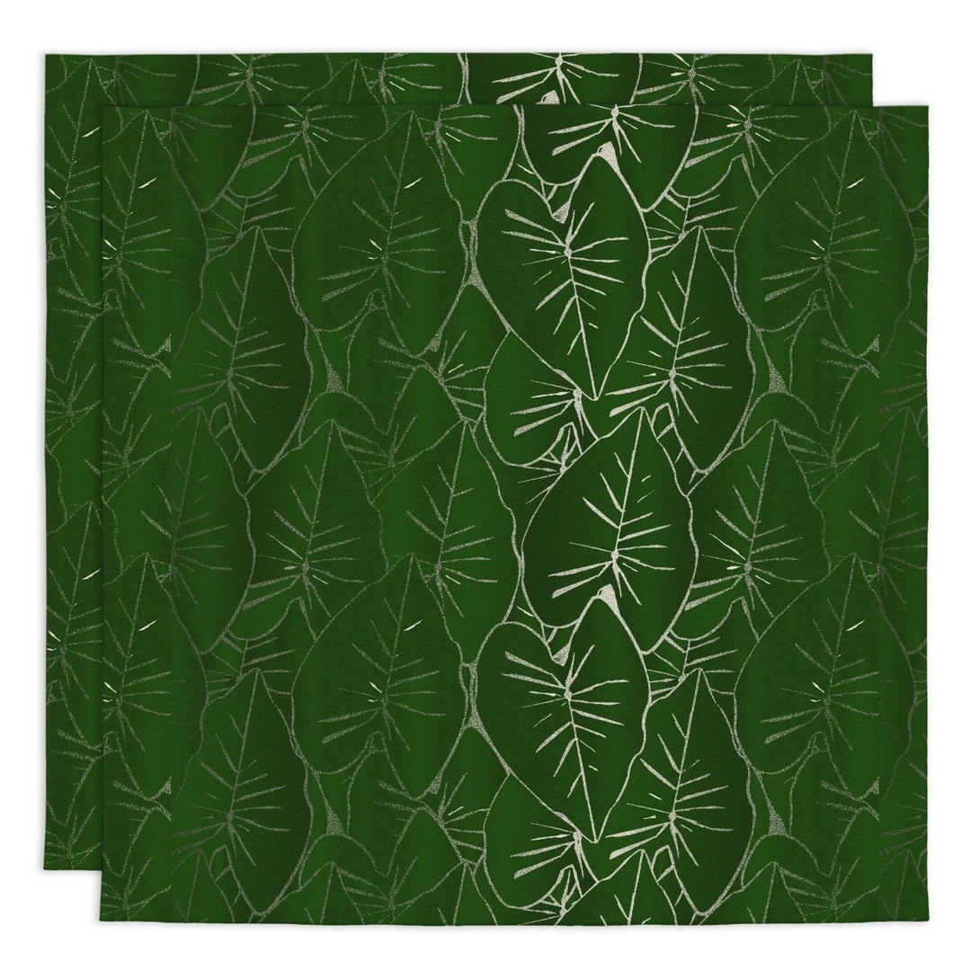 Two green placemats with white leaf pattern on a matching green background