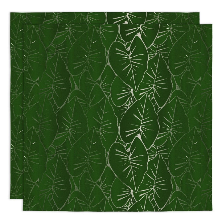Two green placemats with white leaf pattern on a matching green background
