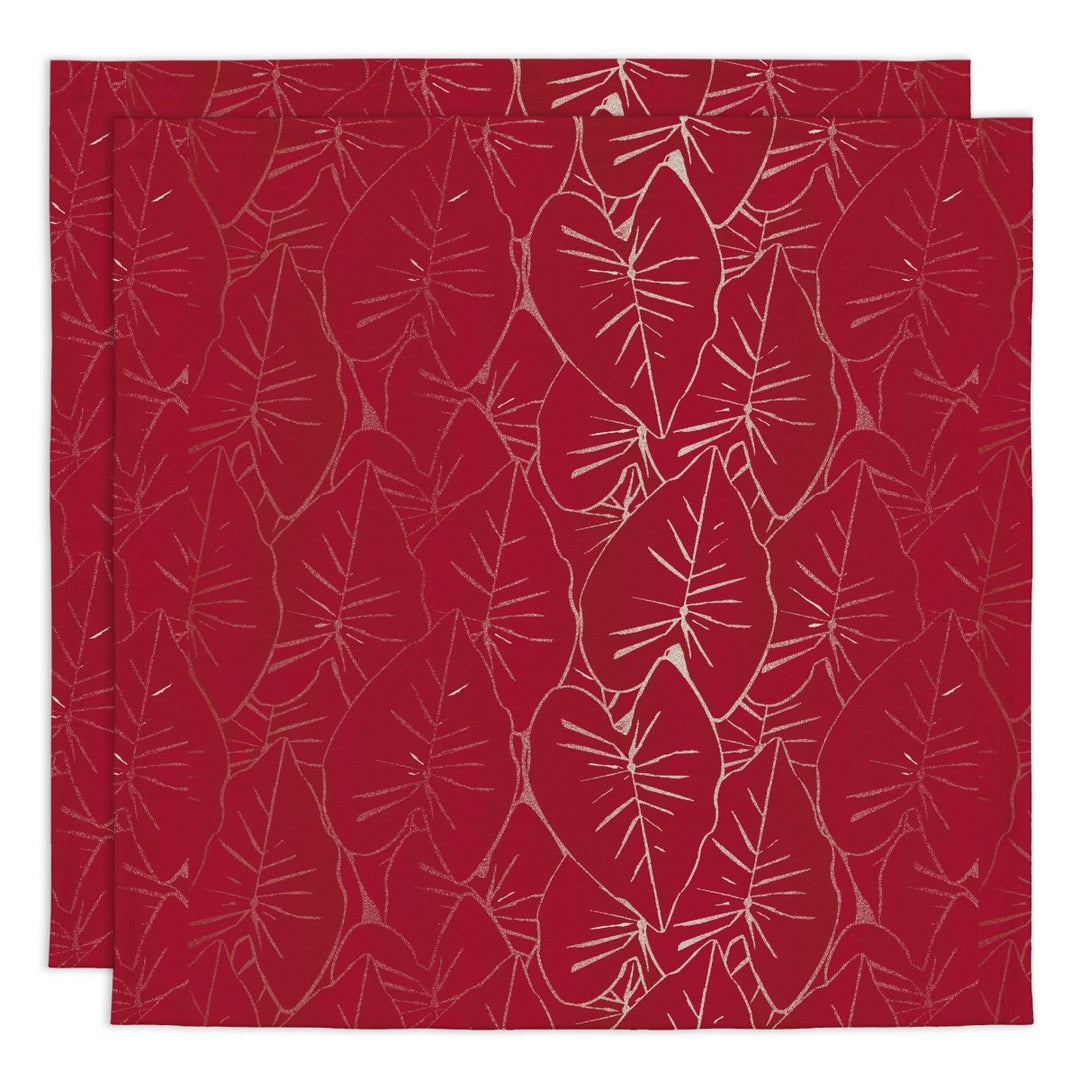 Two red placemats with white leaf pattern on a white background