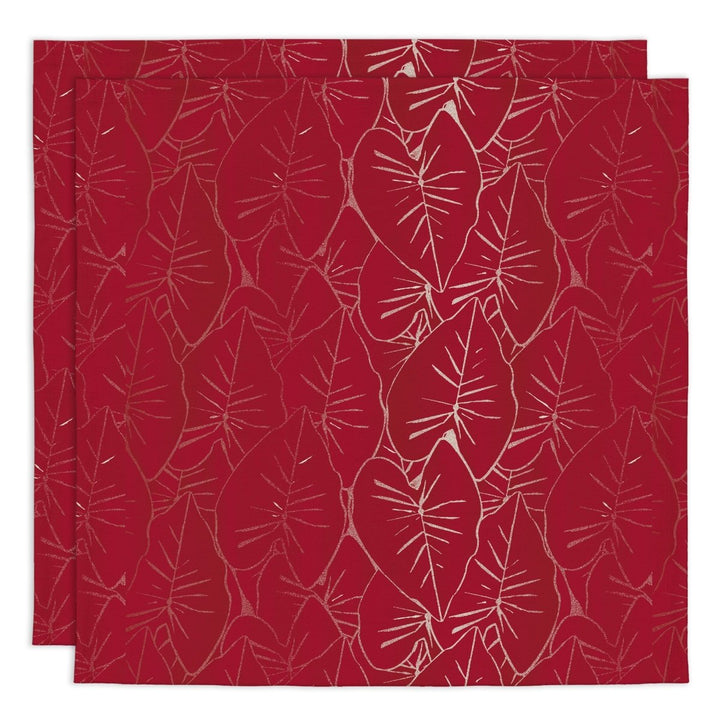 Two red placemats with white leaf pattern on a white background