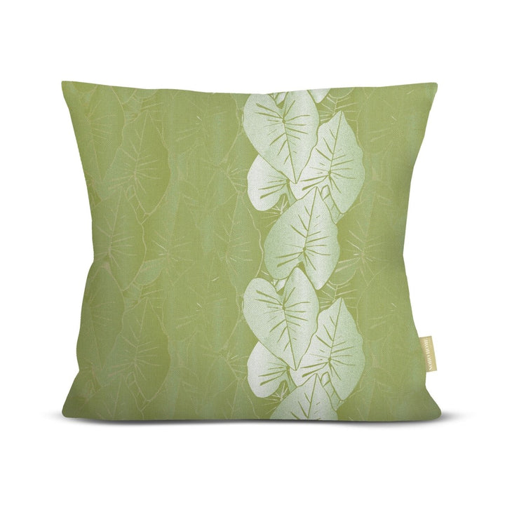 Green pillow with white kalo leaf pattern on a white background