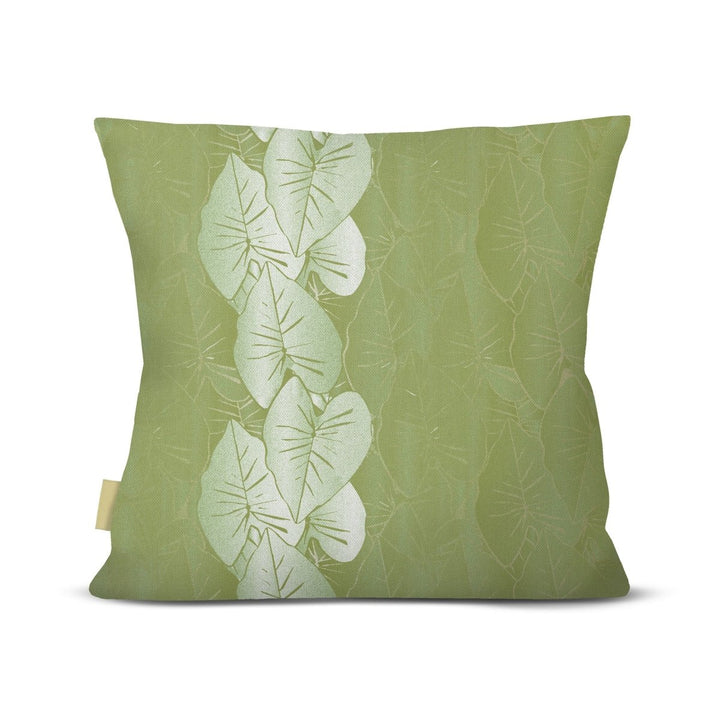Green pillow with leaf pattern on a white background