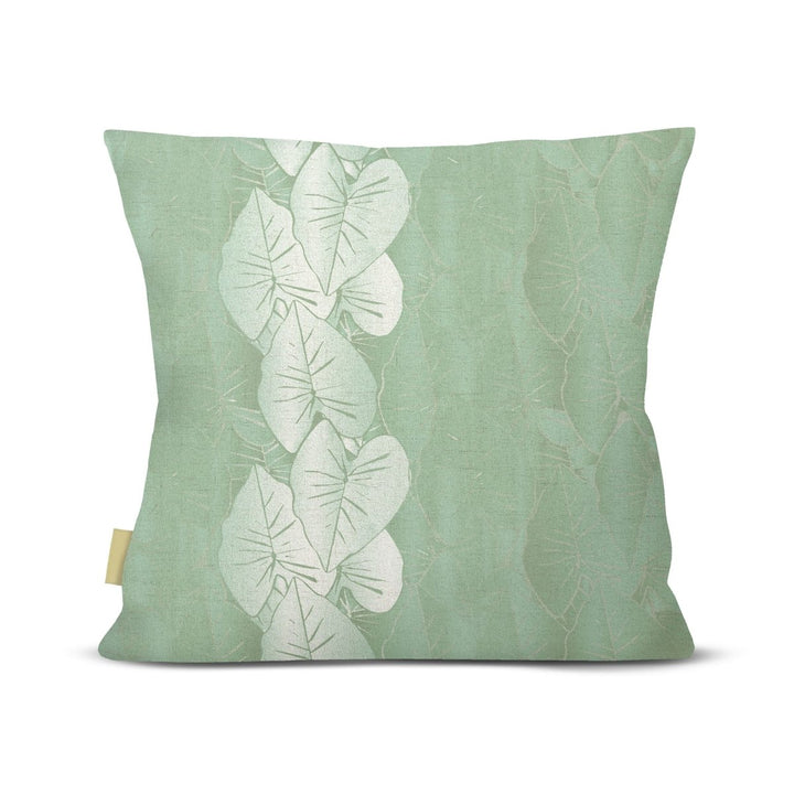 front view green Hānai premium square pillow with white kalo leaves on white background