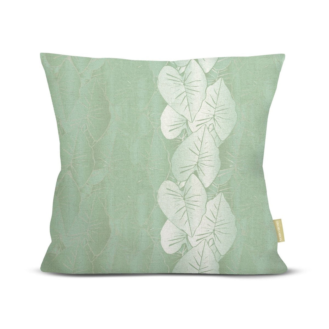 front view green Hānai premium square pillow with white kalo leaves on white background