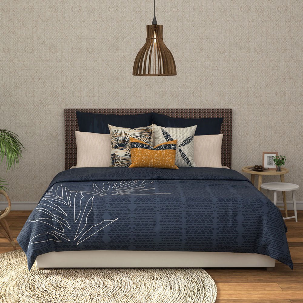 Hōʻolu Hiamoe Coastal Comforter In Dark Blue On a Large Bed With Colorful Decor Pillows