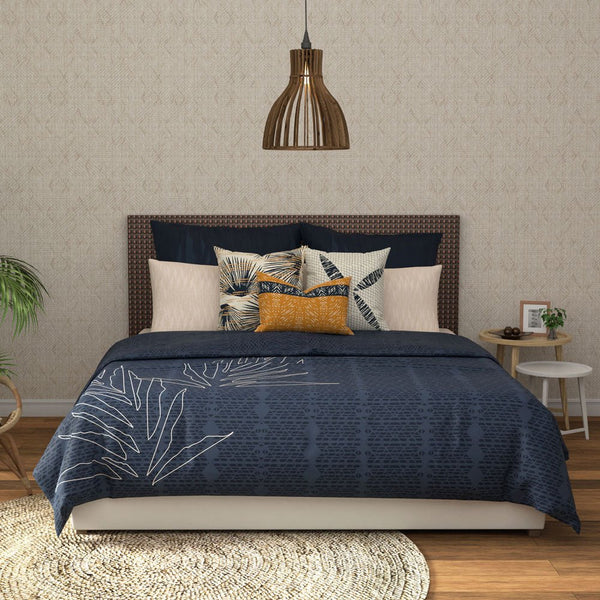 Hōʻolu Hiamoe Coastal Comforter In Dark Blue On a Large Bed With Colorful Decor Pillows